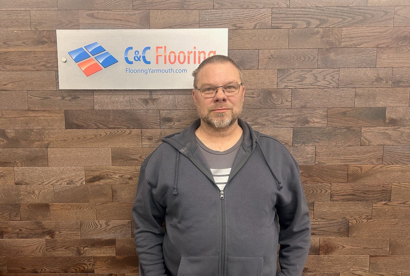 A silhouette of a man without a face on a gray background.