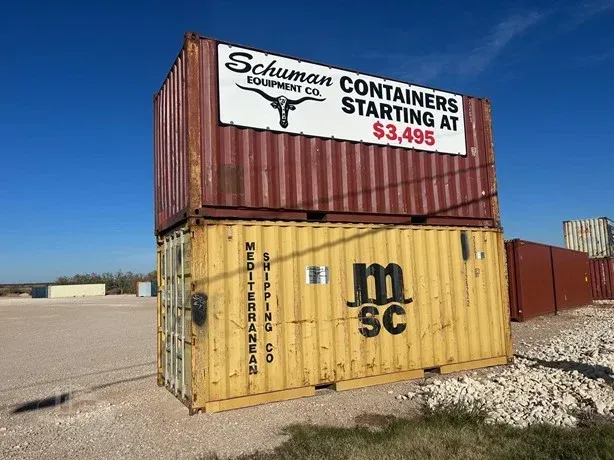 Stacked shipping containers in a gravel lot, including a yellow MSC container and a red container labeled “Containers starting at $3,495.”