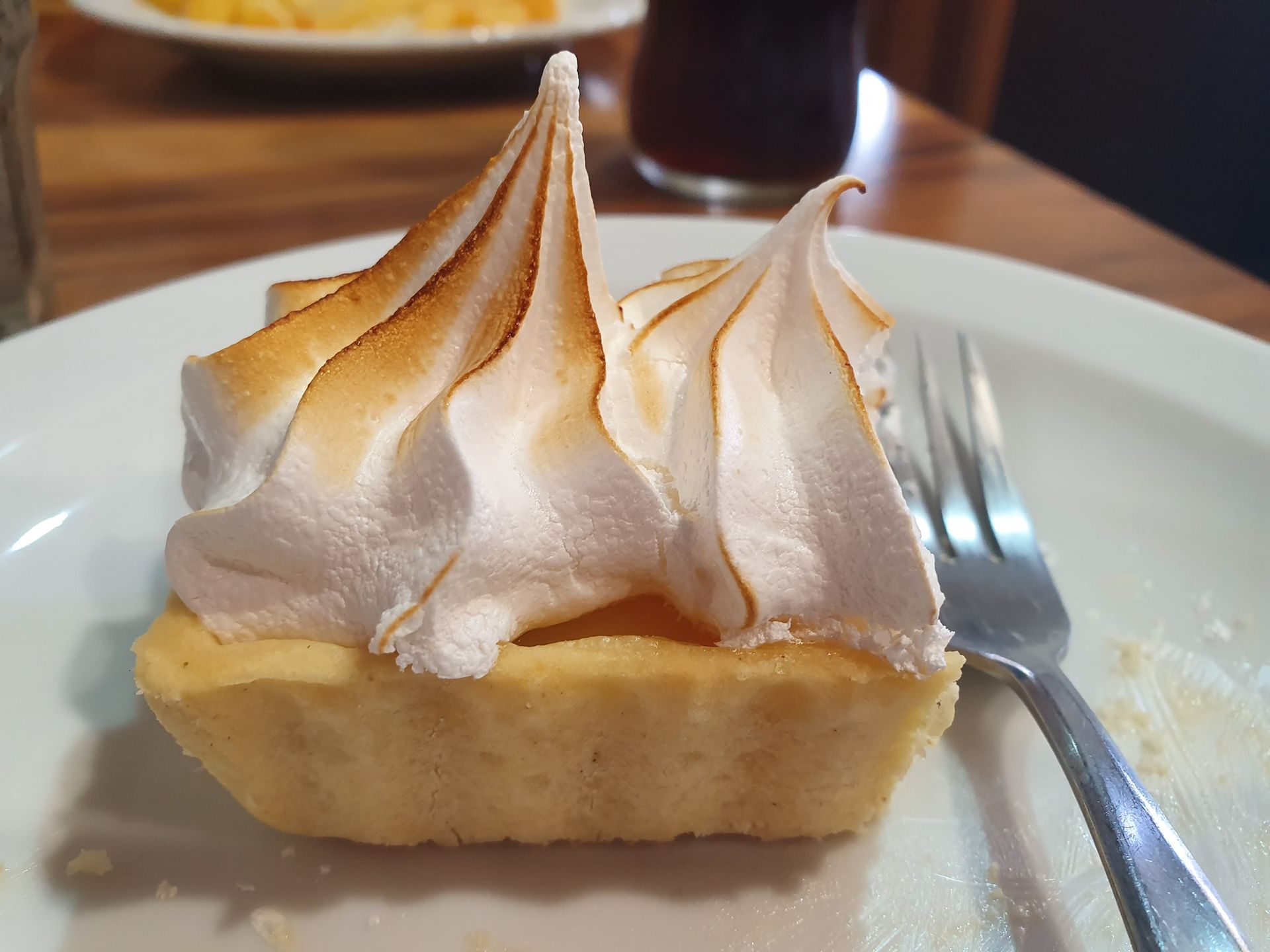 Lemon Meringue Tart on A White Plate, Fork, Golden Meringue — Kape Centro In Childers, QLD 