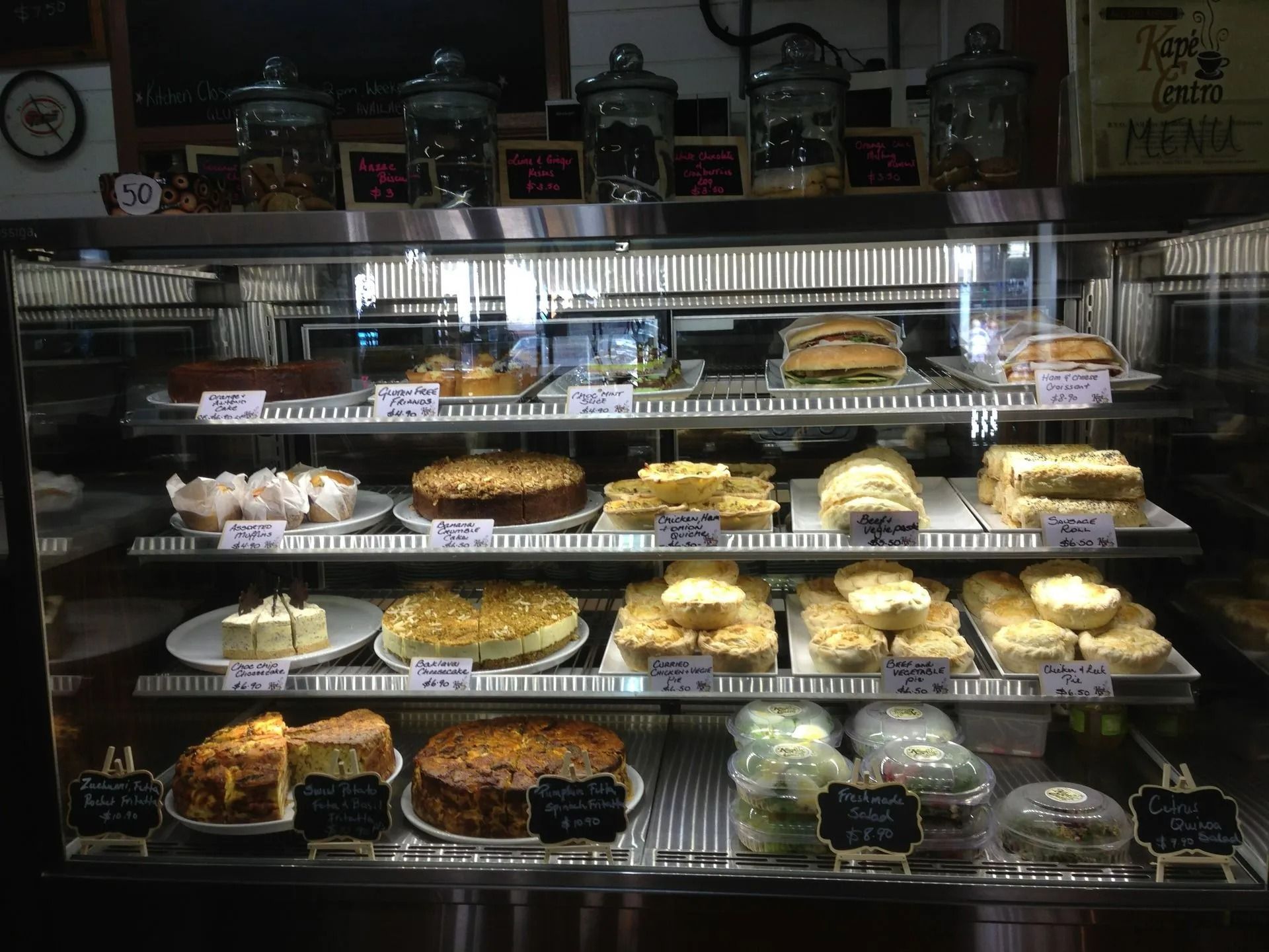 Bakery Display Case Filled with Various Cakes — Kape Centro In Childers, QLD 