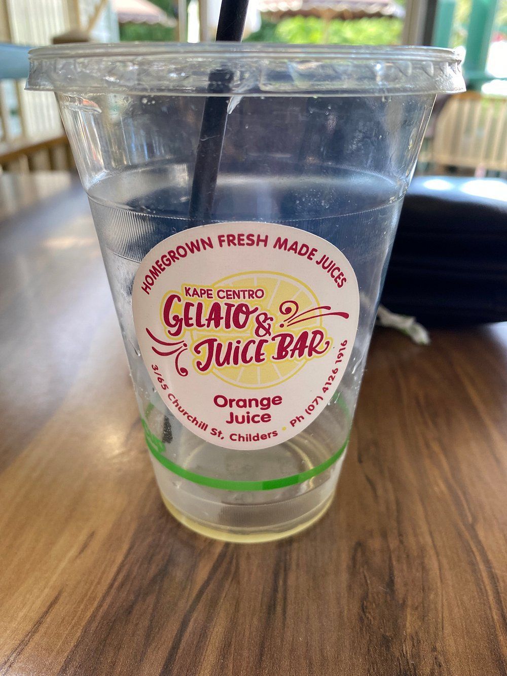 Empty Plastic Cup with Straw on A Wooden Table — Kape Centro In Childers, QLD