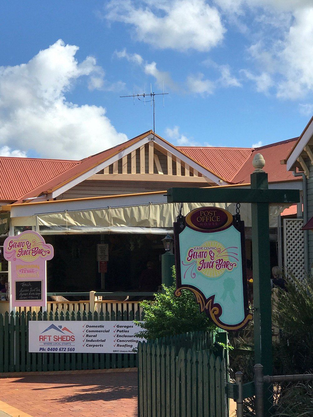 Cafe with Colorful Signs and A Light Blue Sky — Kape Centro In Childers, QLD