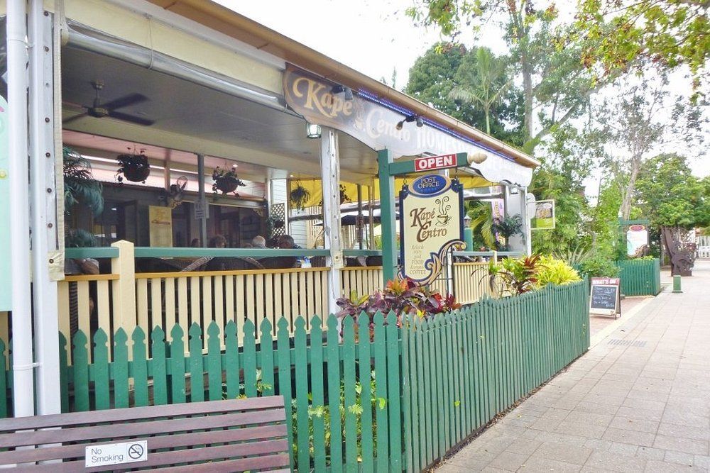 Cafe with Green Picket Fence, Open Sign, Sidewalk Seating — Kape Centro In Childers, QLD