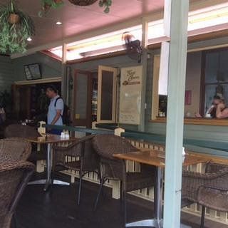 Inside a Cafe with Tables, Chairs, and A Man in A Blue Shirt — Kape Centro In Childers, QLD