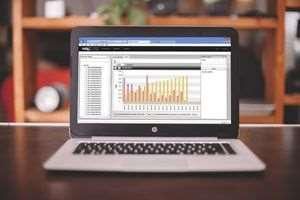 Una computadora portátil está sobre una mesa con un gráfico en la pantalla.