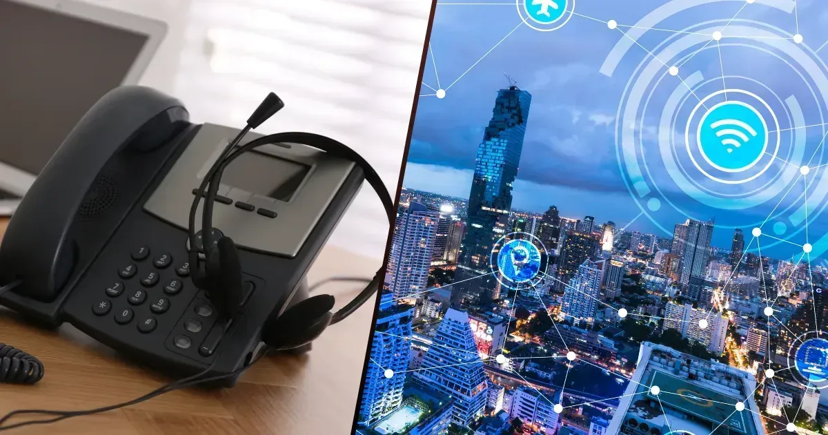 A desk phone with a headset beside a digital overlay of a cityscape with interconnected Wi-Fi