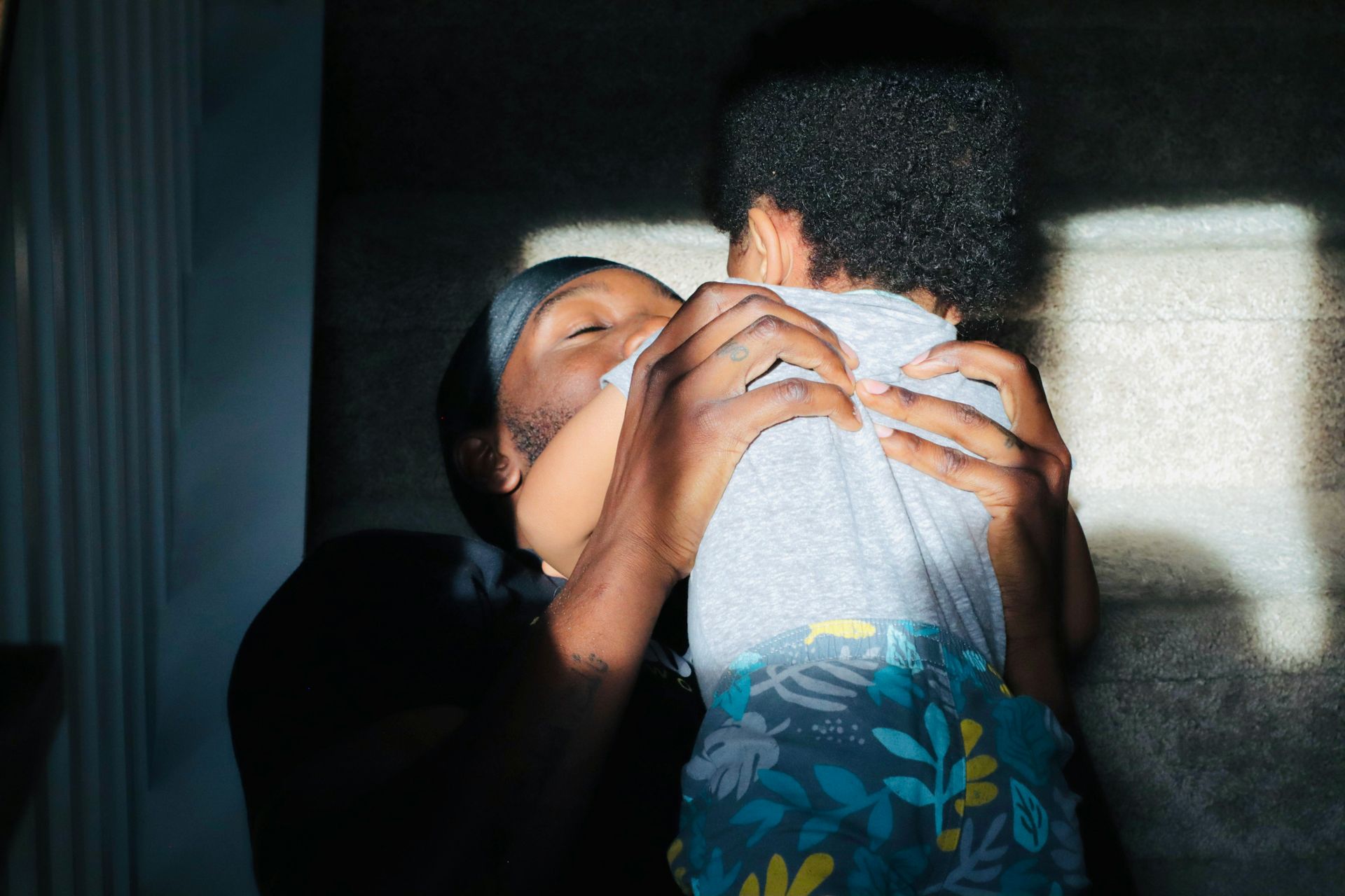A woman is holding a baby in her arms.