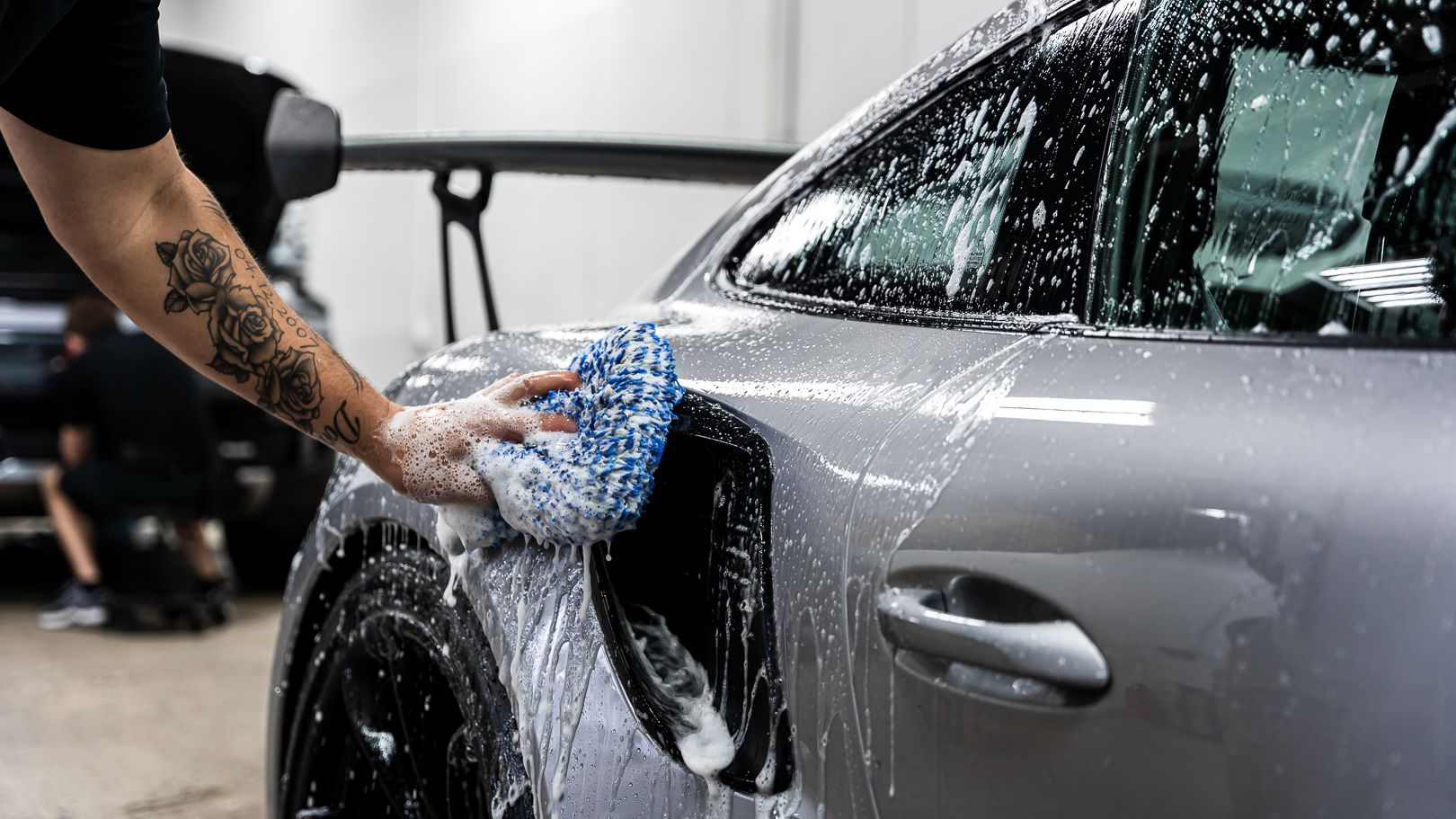 Using a wash mitt to clean paint on vehicle