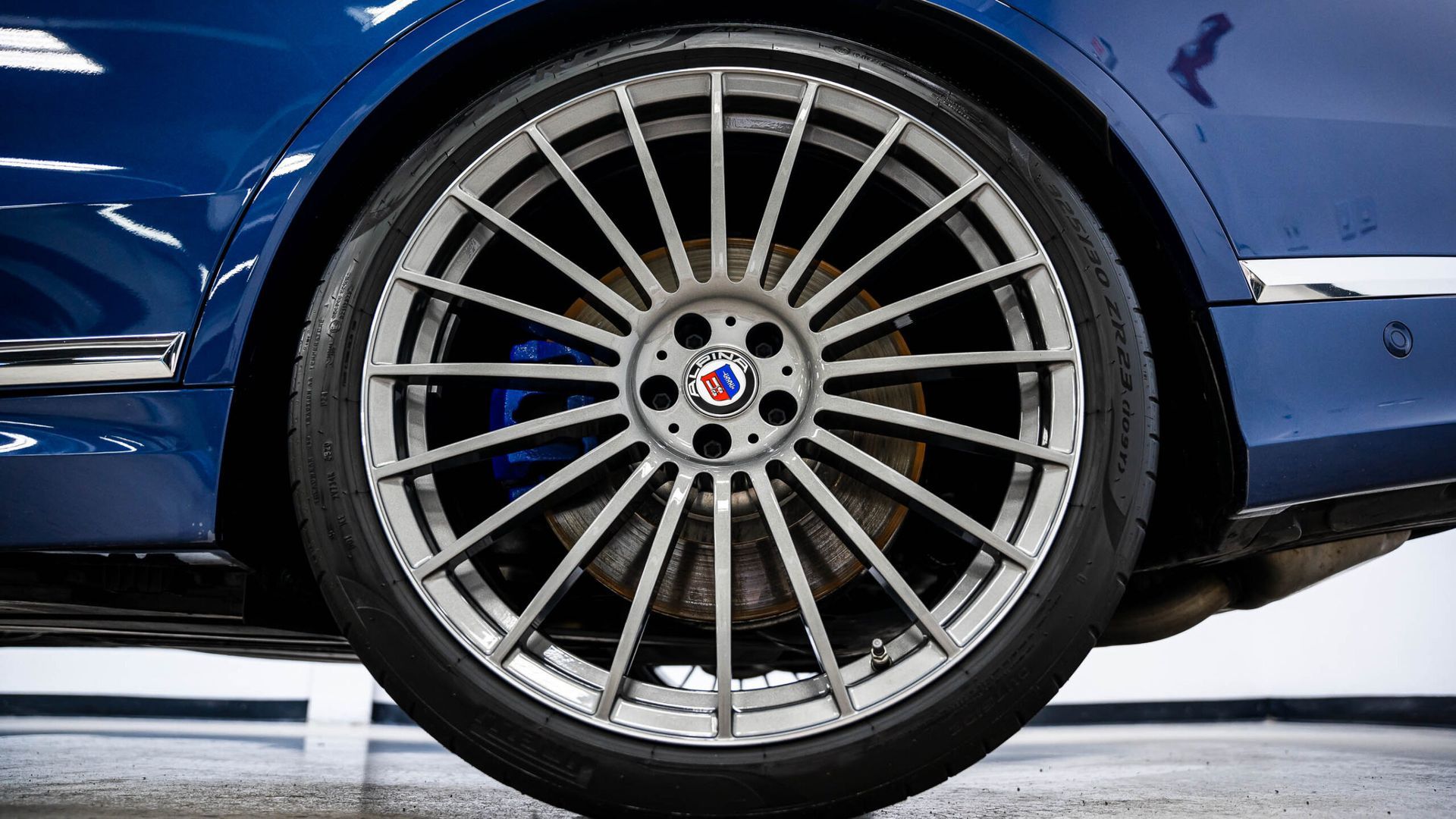 A close up of a car wheel with a tire on it.