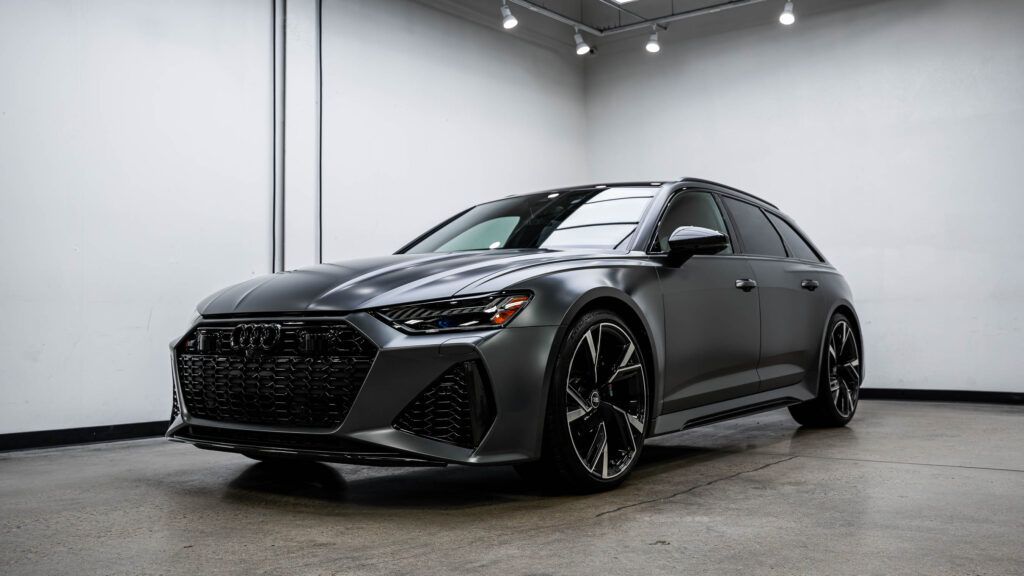 A gray audi rs6 is parked in a garage.