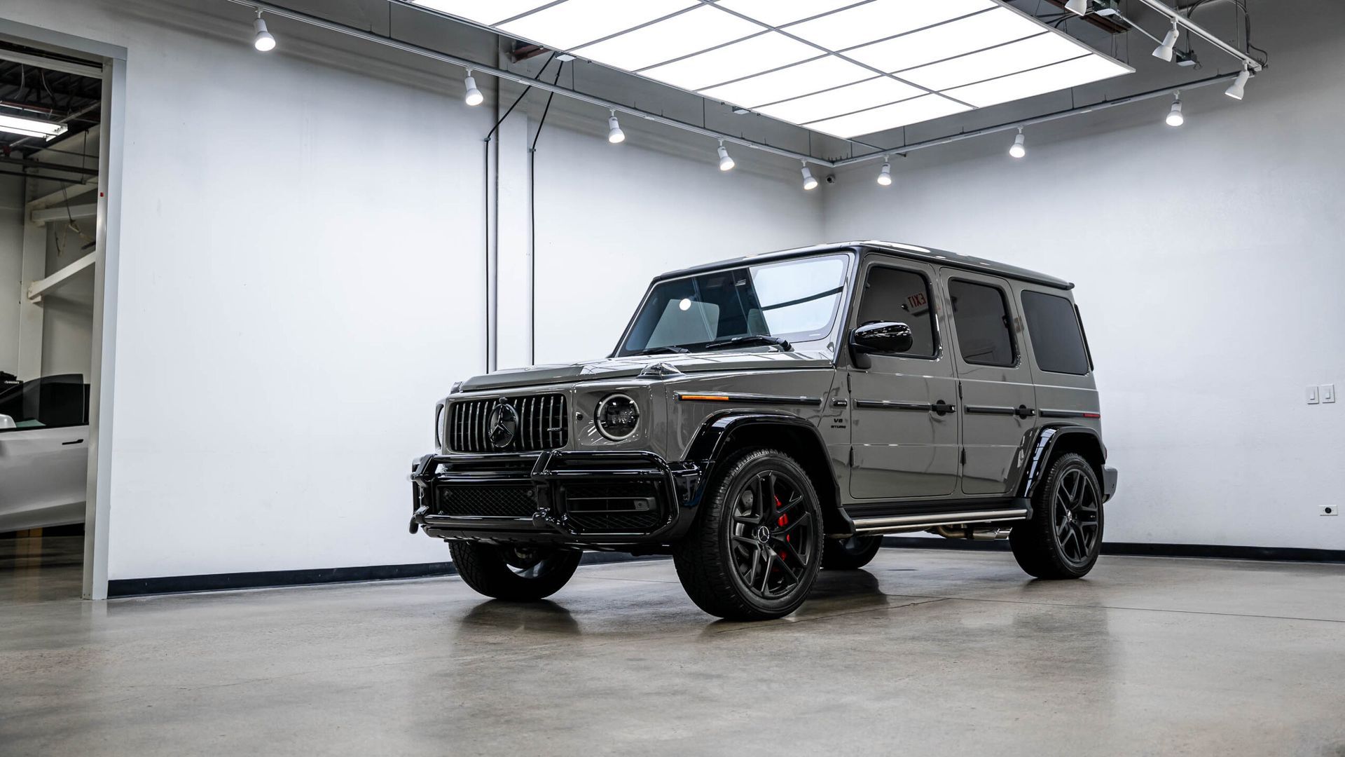 A mercedes benz g63 amg is parked in a garage.