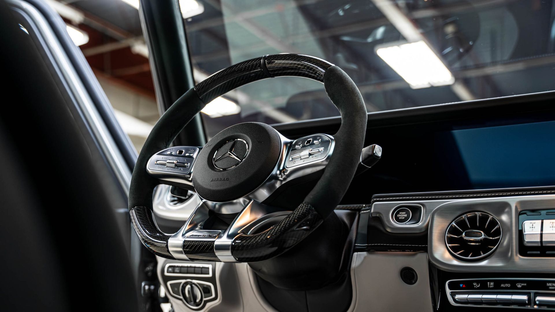 A close up of a steering wheel in a car.