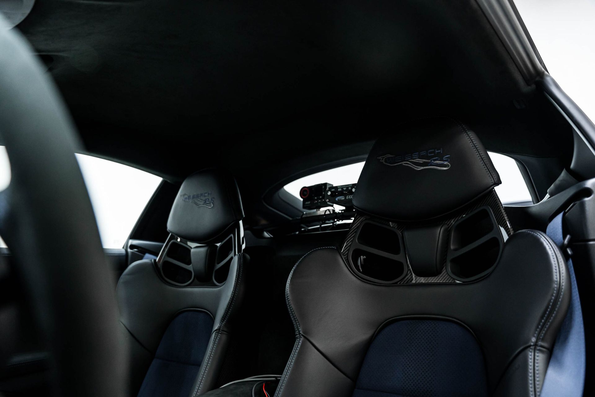 The inside of a sports car with the roof up