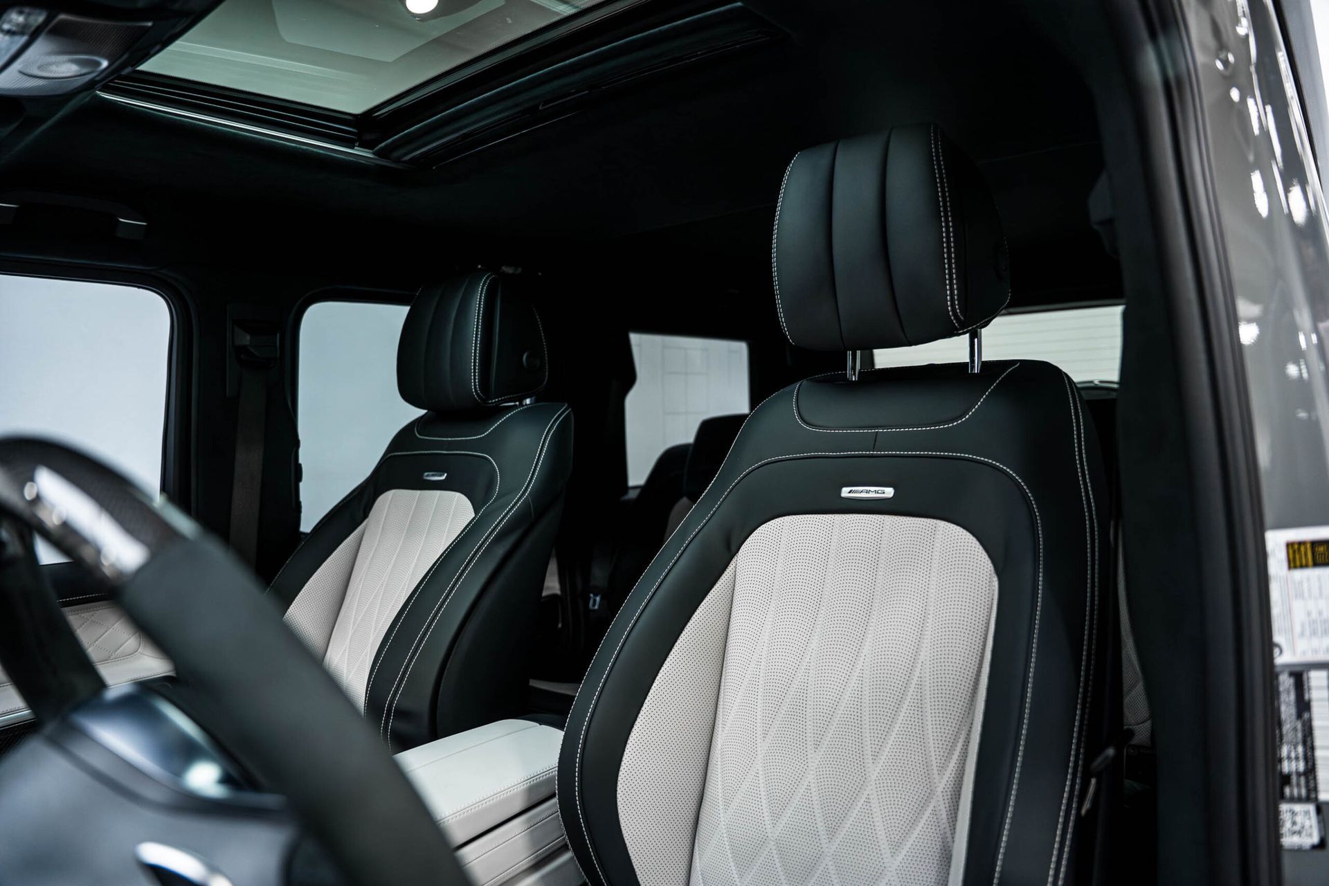 The interior of a mercedes benz g63 amg with a sunroof.