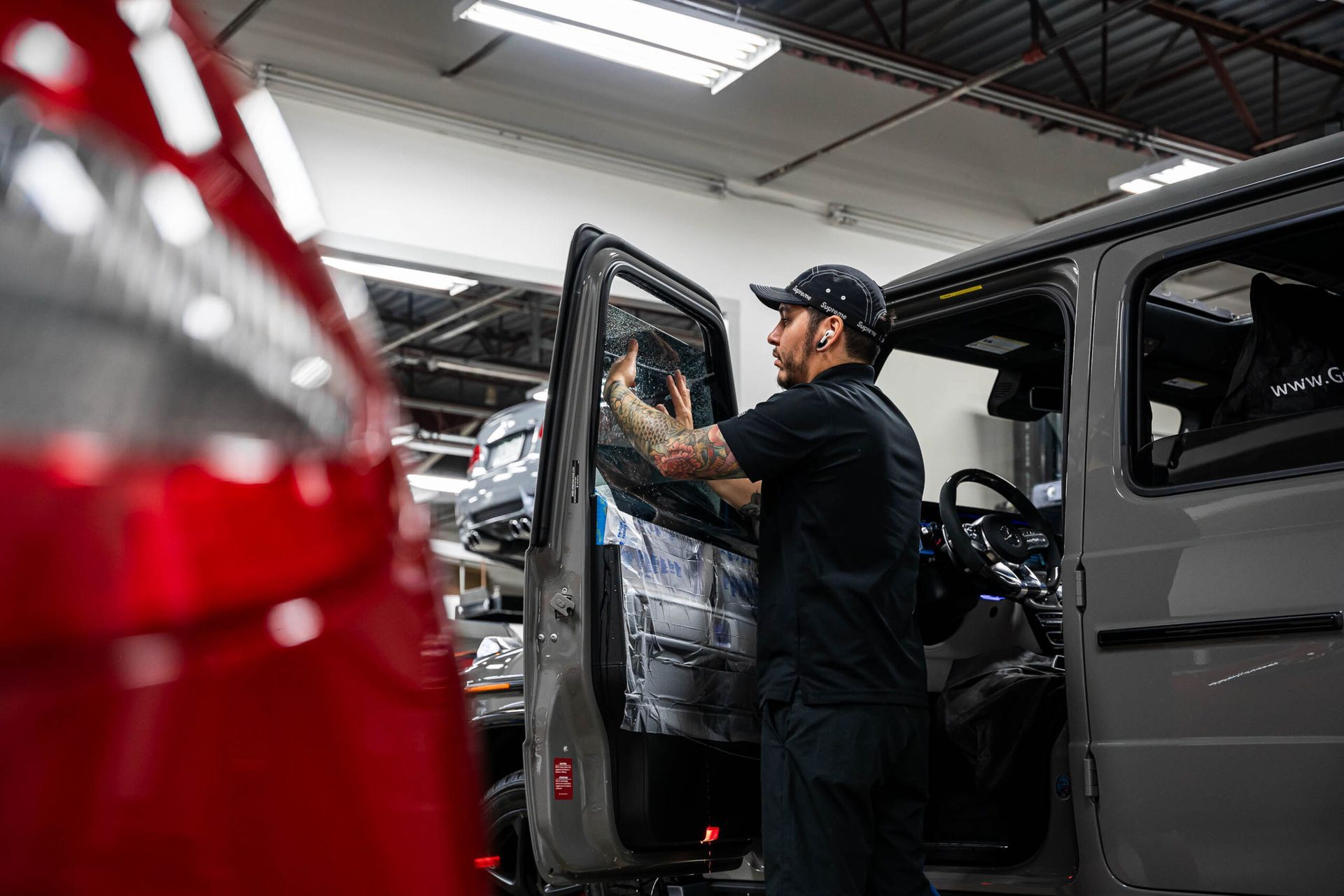 A man is working on a car in a garage.