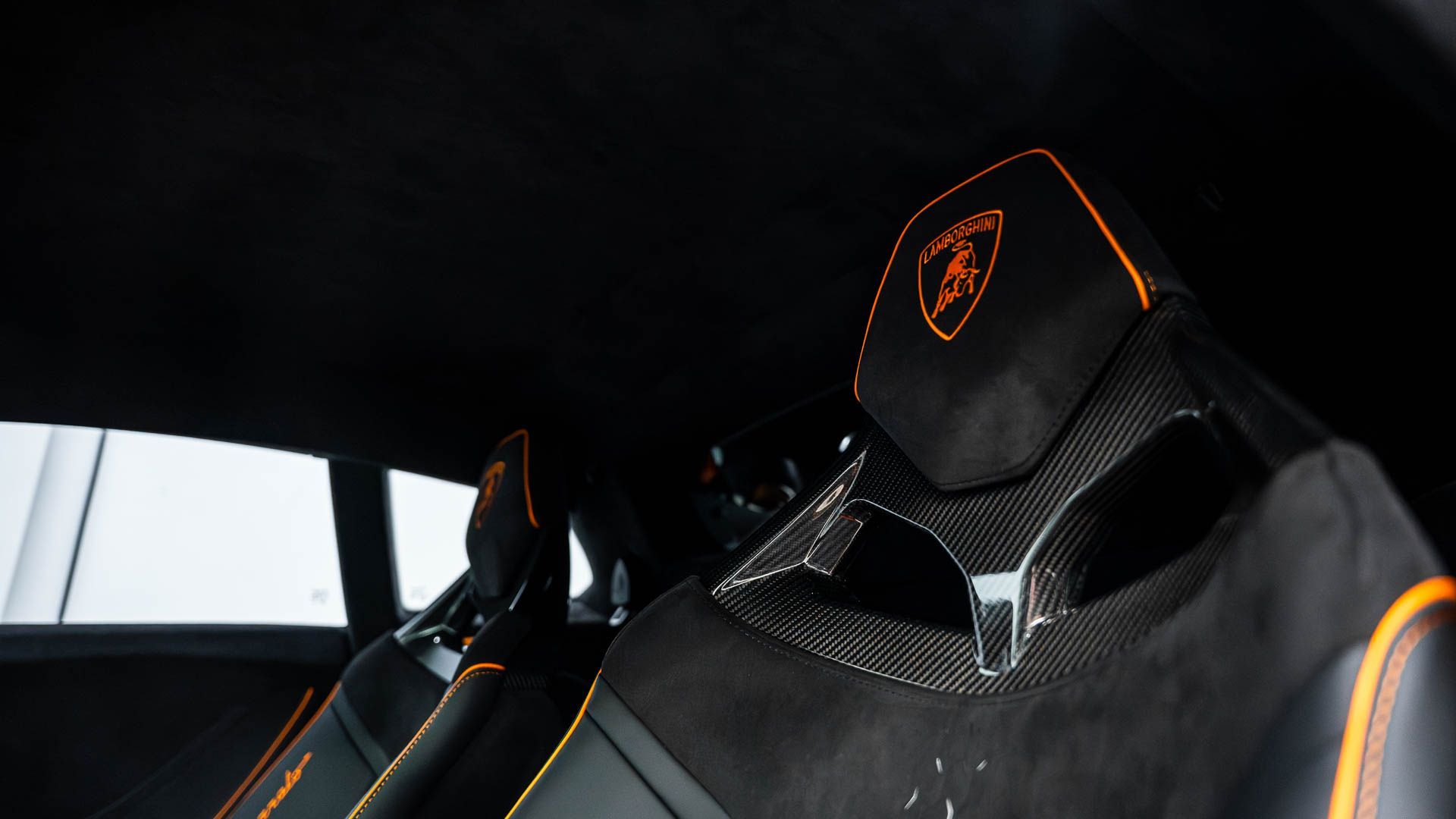 A close up of a lamborghini seat in a car.