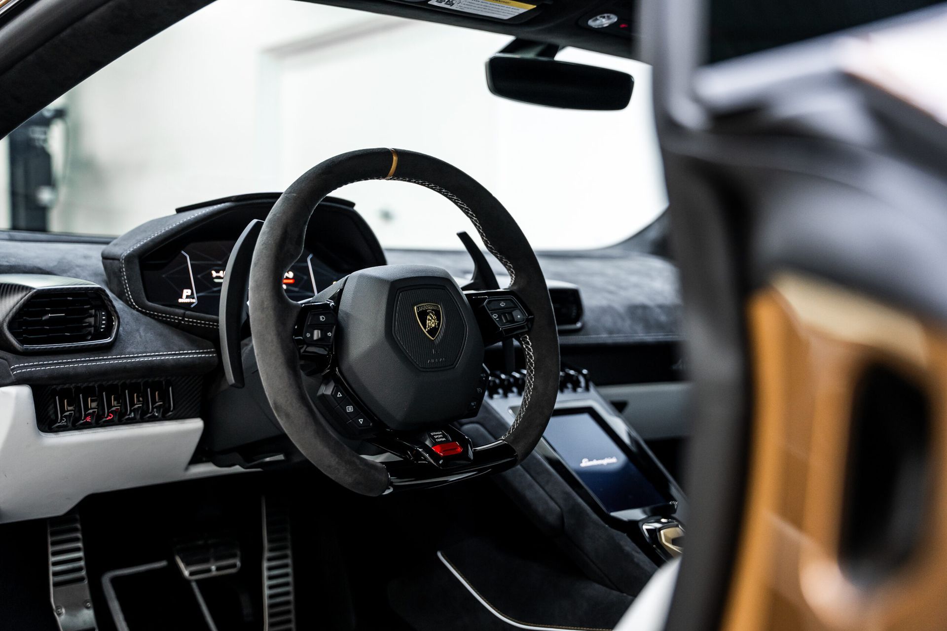 A close up of the steering wheel of a lamborghini huracan