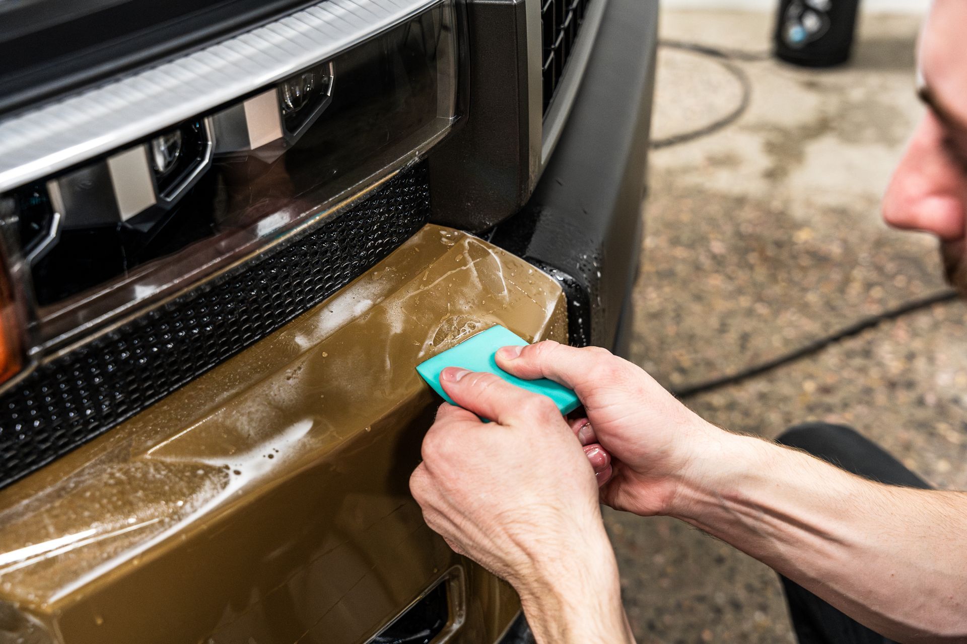 paint protection film installation on a gold car
