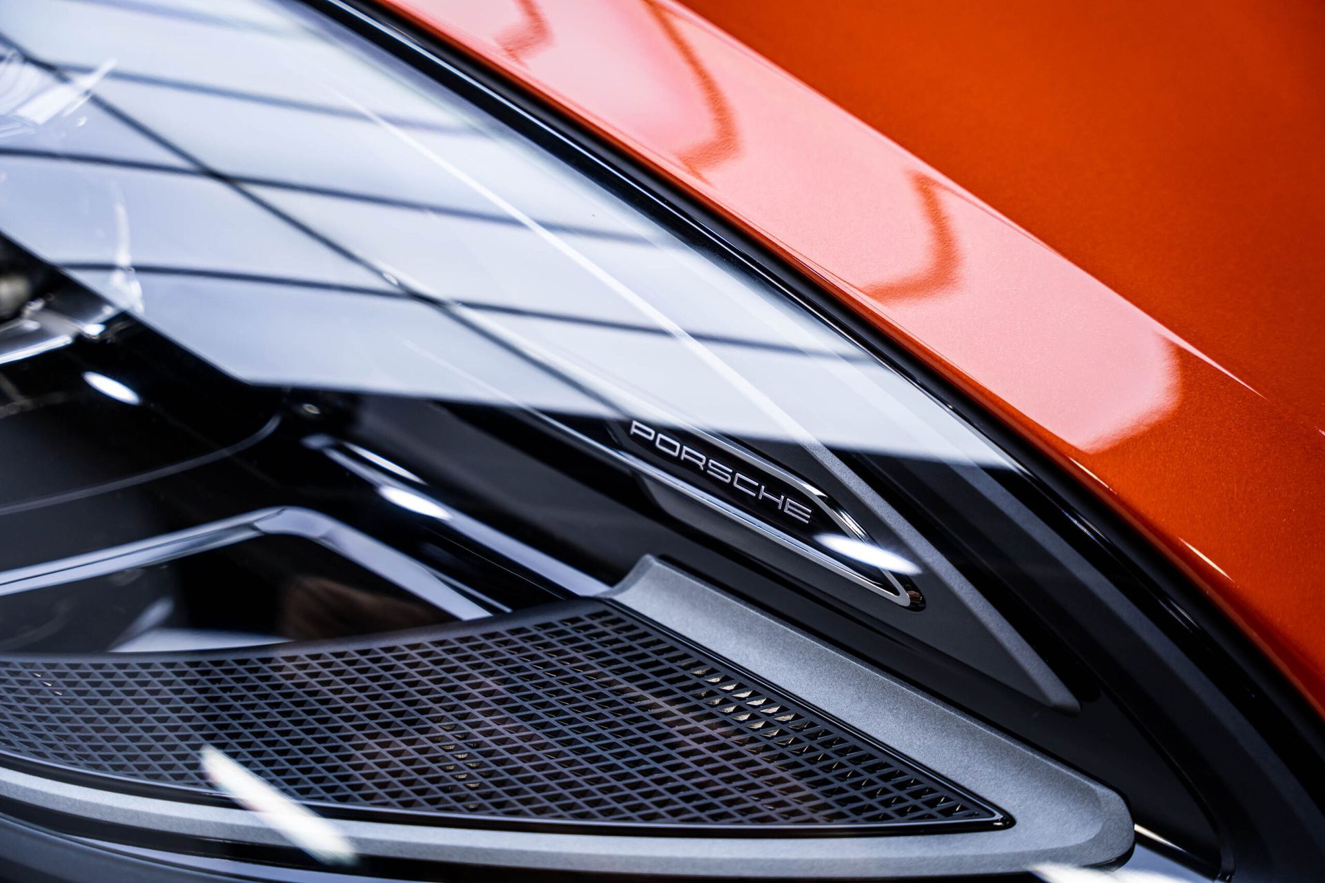 A close up of a car headlight with a speaker on it