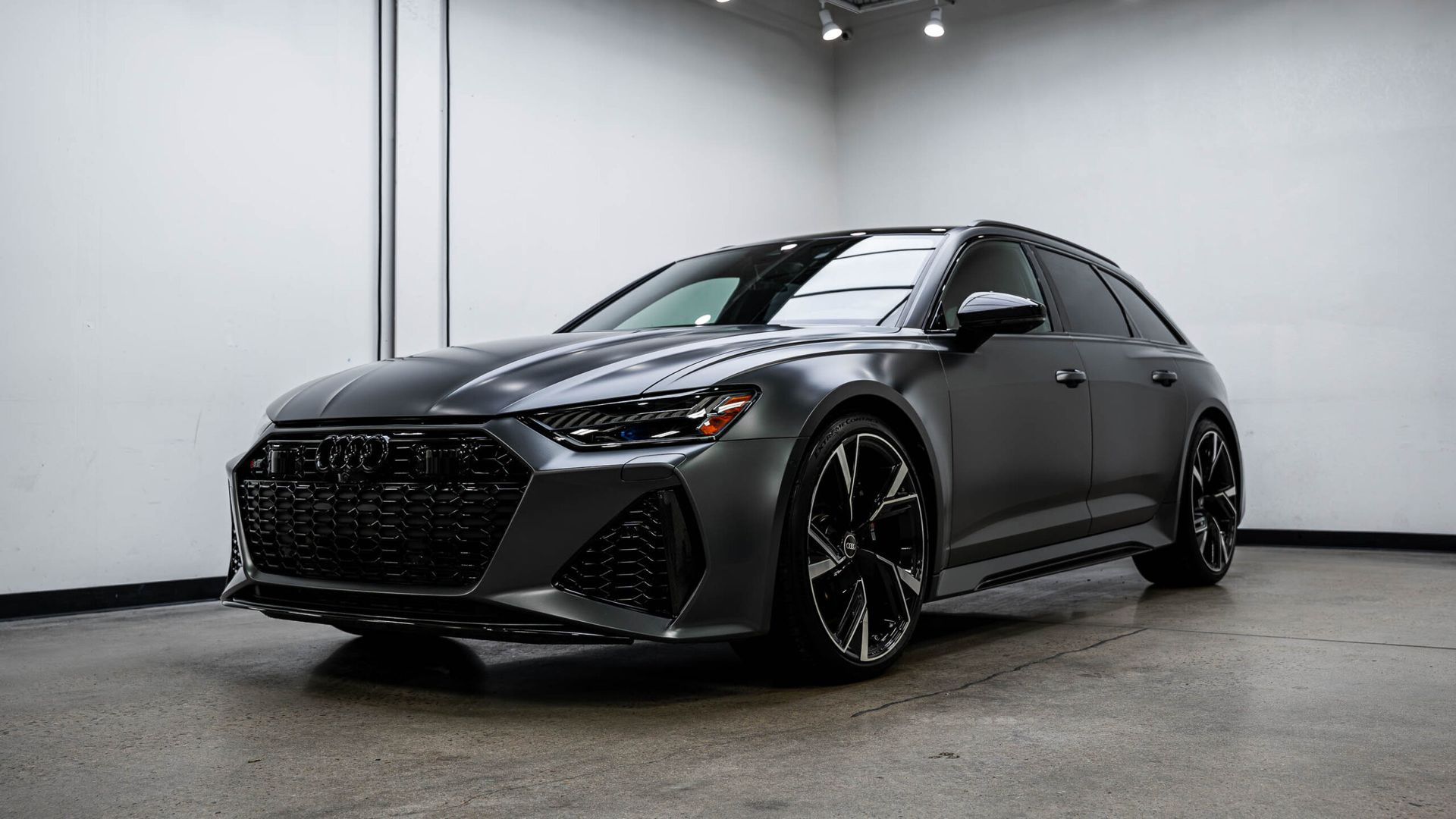 A gray audi rs6 is parked in a garage.