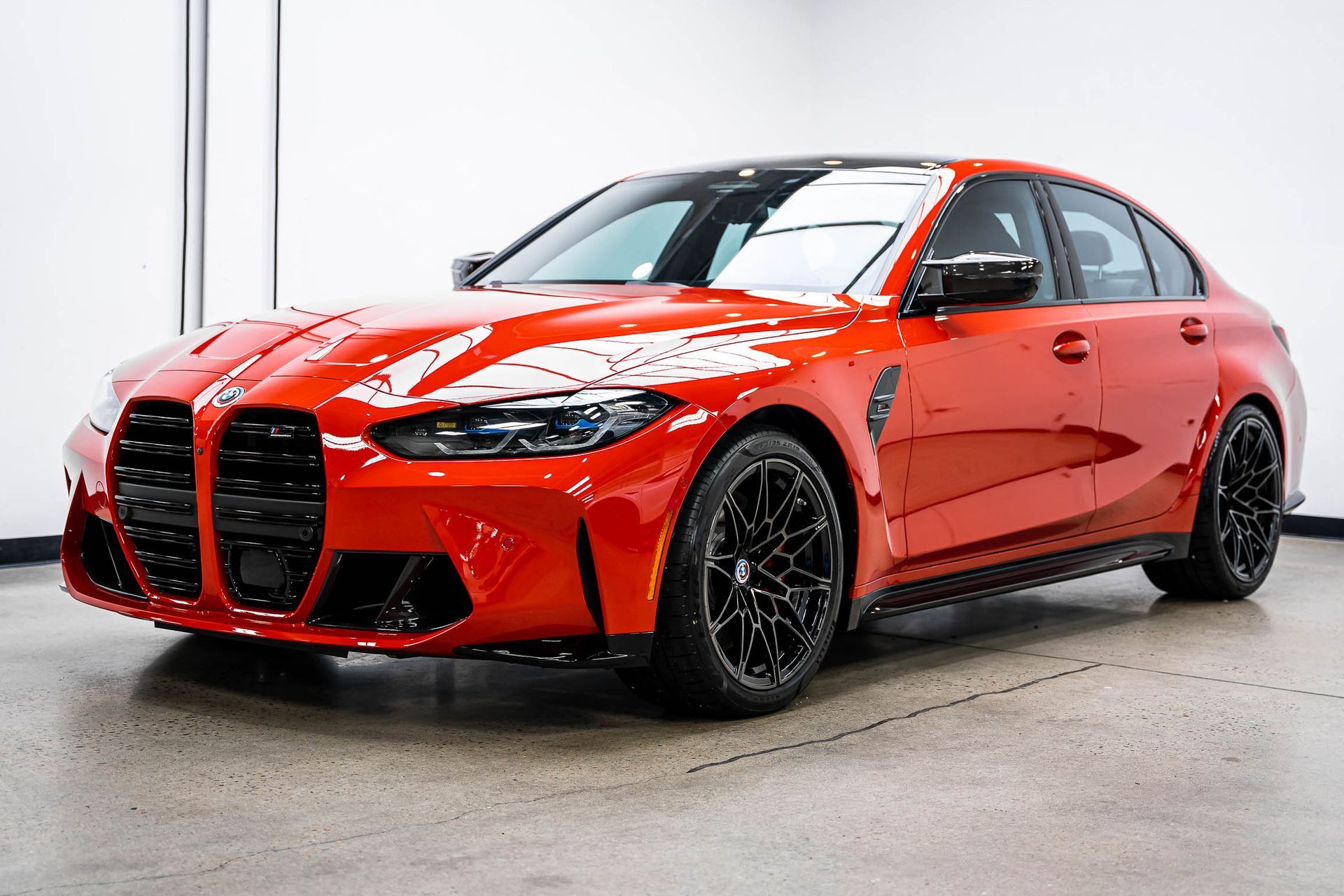 A red bmw m3 is parked in a garage.