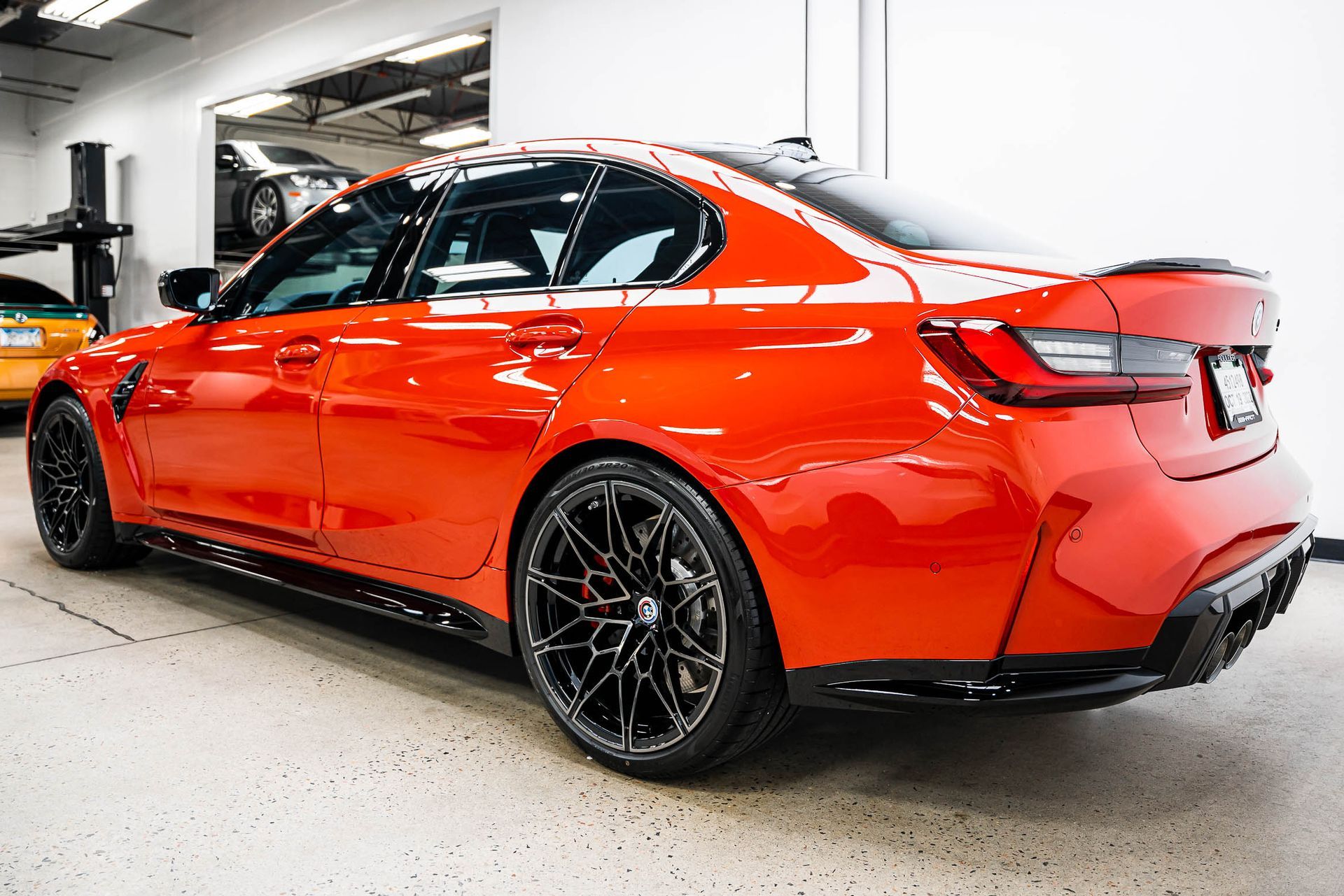 A red bmw m3 is parked in a garage.