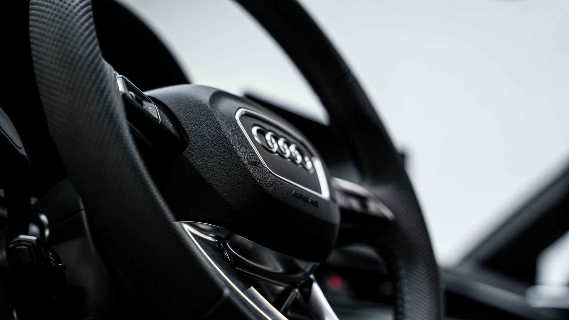 A close up of the steering wheel of a car