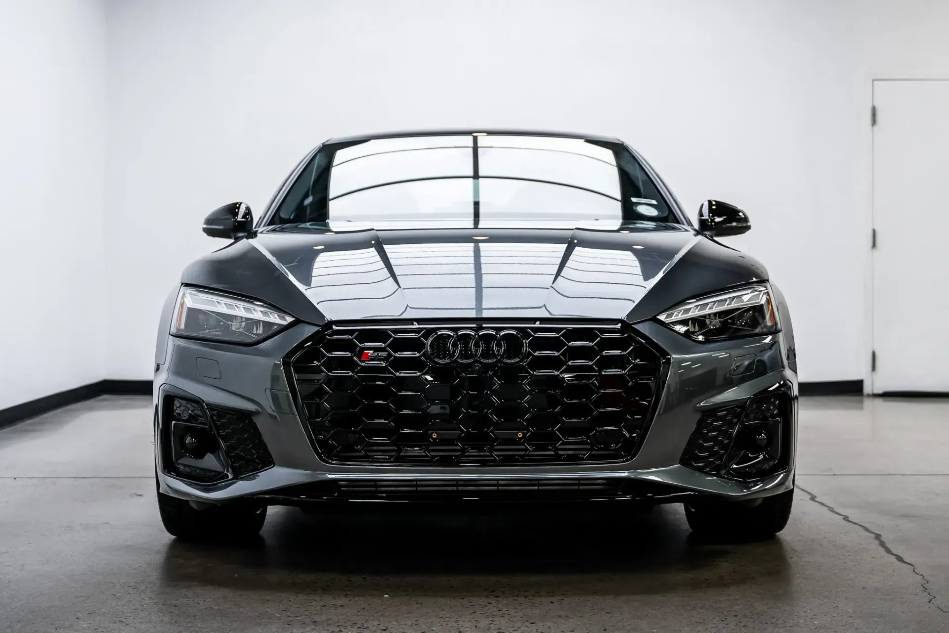 A black audi rs7 is parked in a garage.