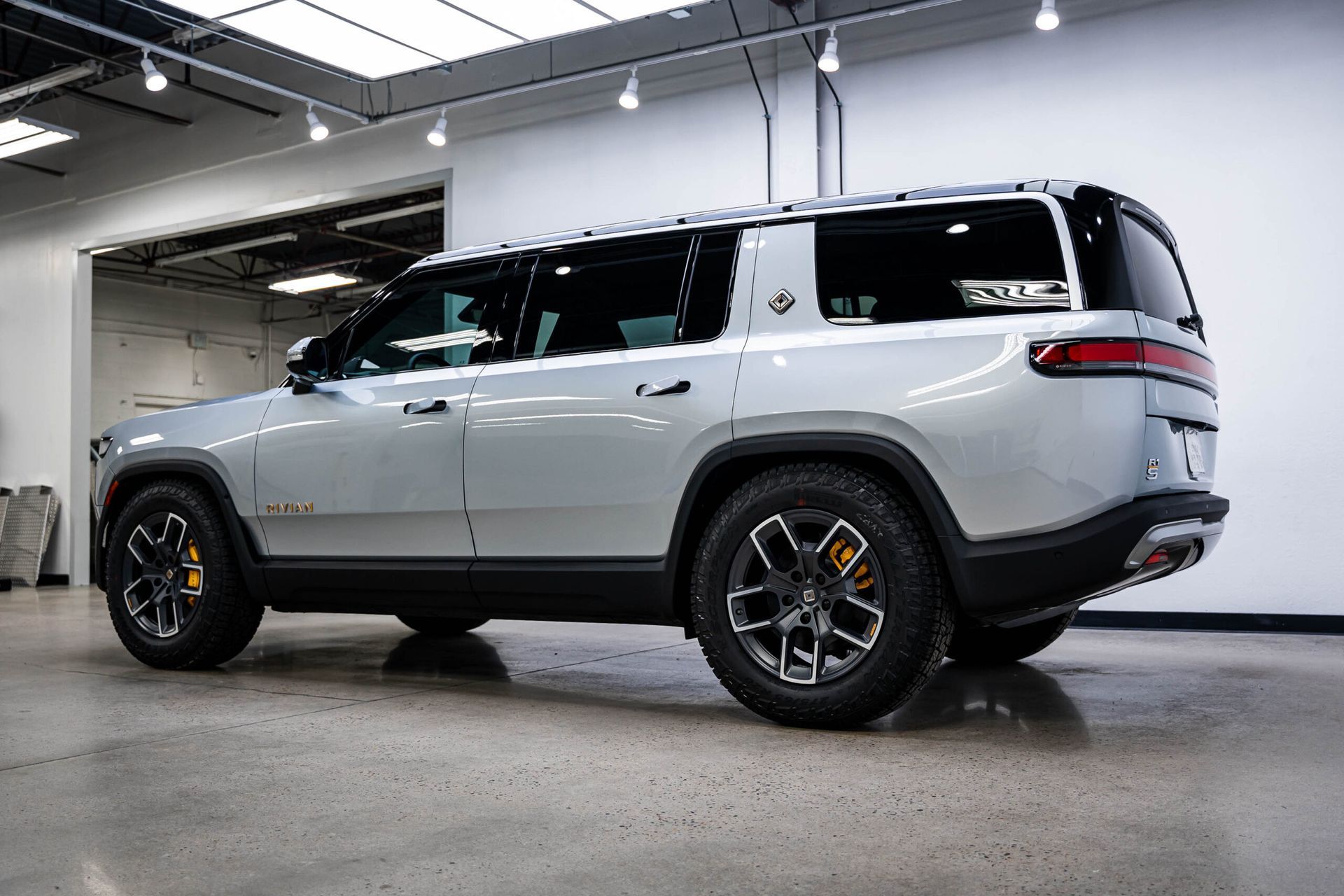 A silver suv is parked in a garage.