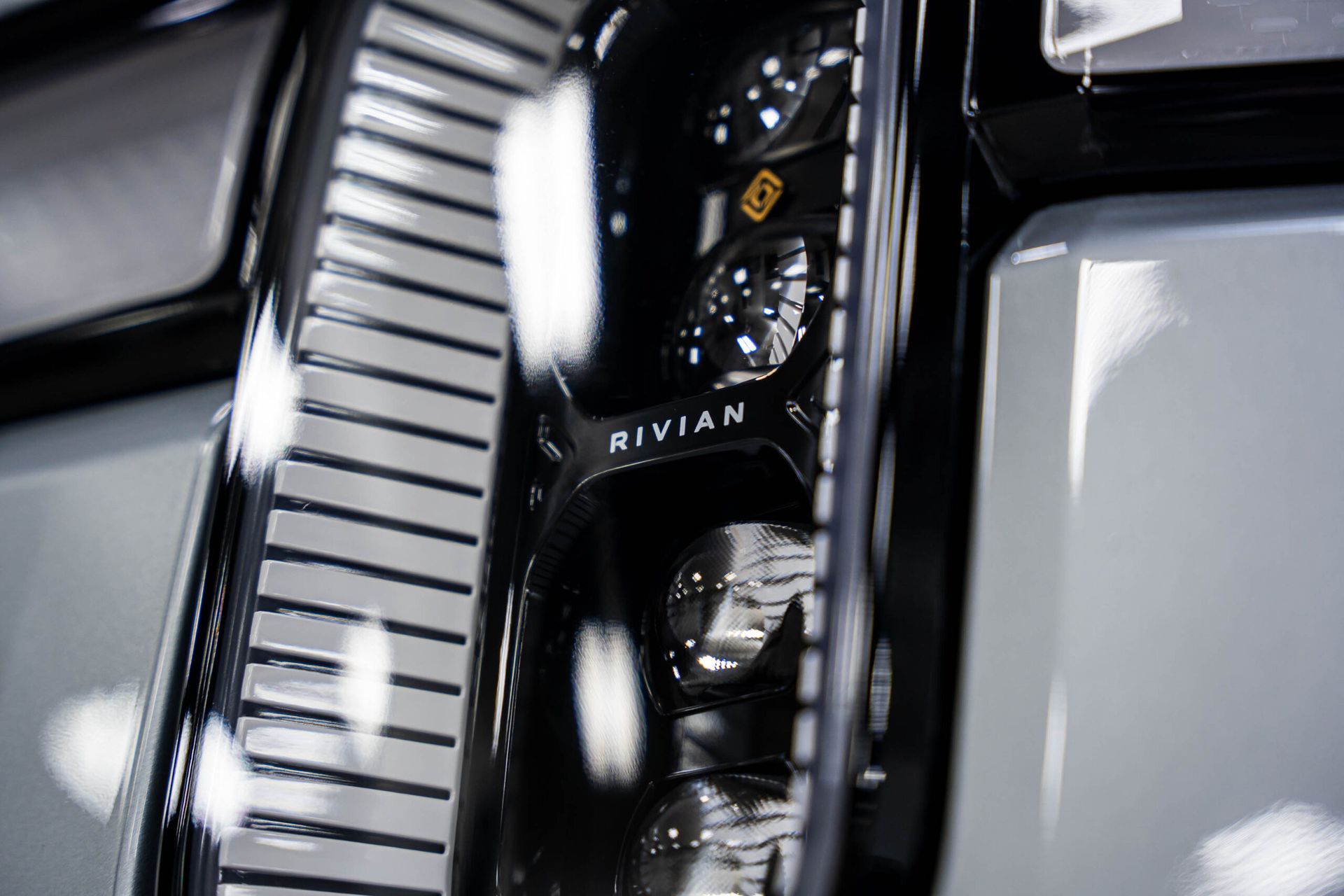 A close up of a car headlight with the word rivian on it