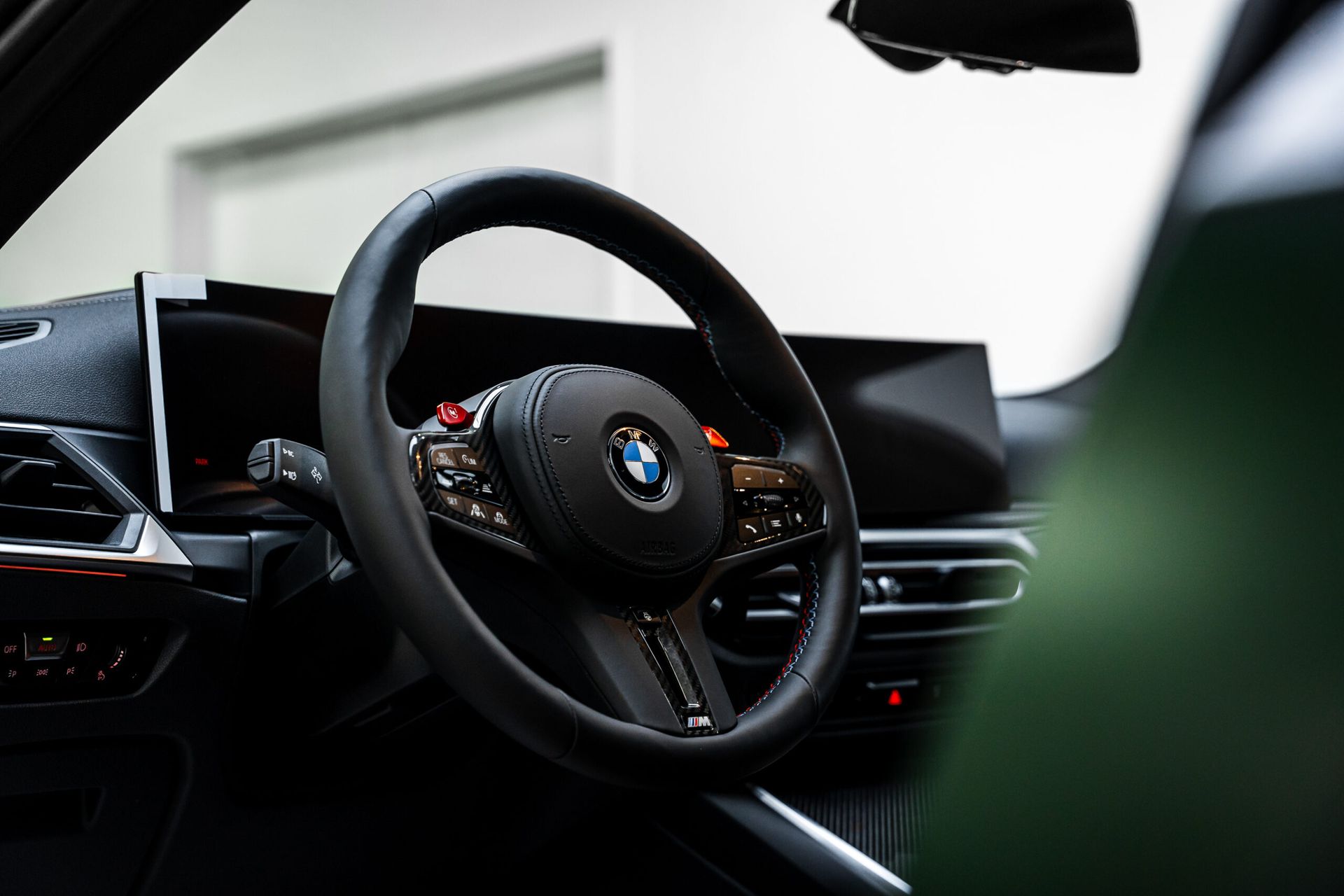 A close up of a steering wheel in a car.