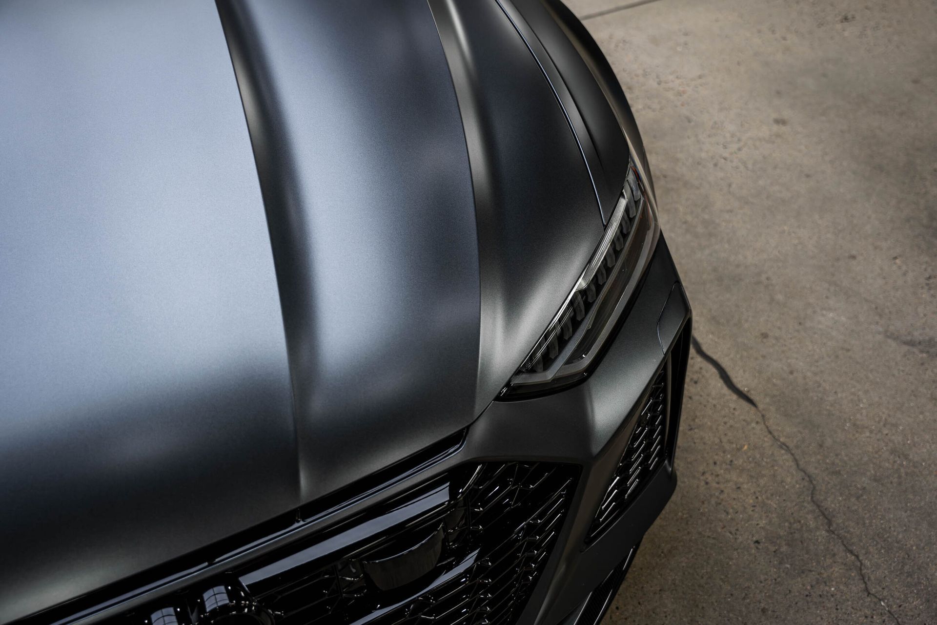 A close up of the hood of a black car.