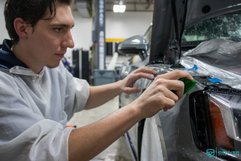 A man is working on a car in a garage.