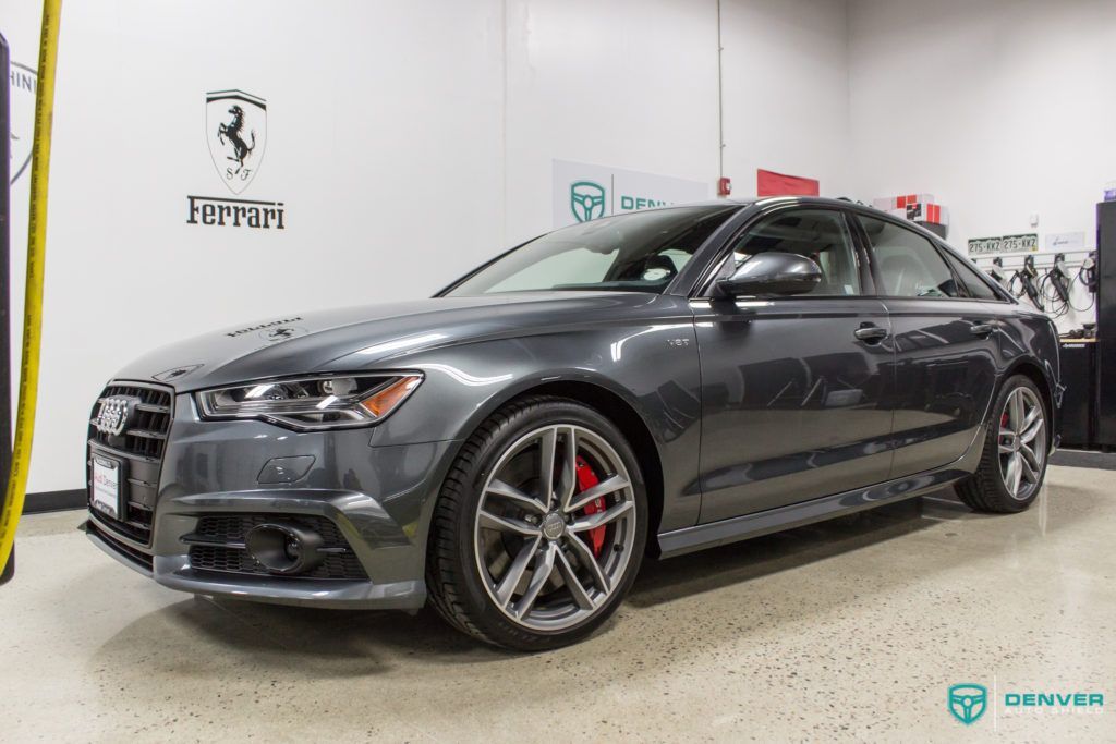 A gray audi a6 is parked in a garage.