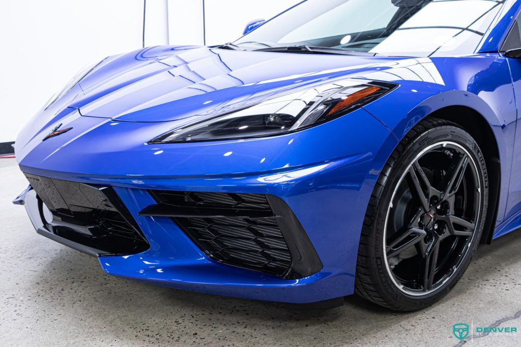 A blue sports car is parked in a garage.