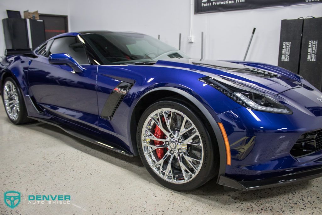 A blue corvette zr1 is parked in a garage.