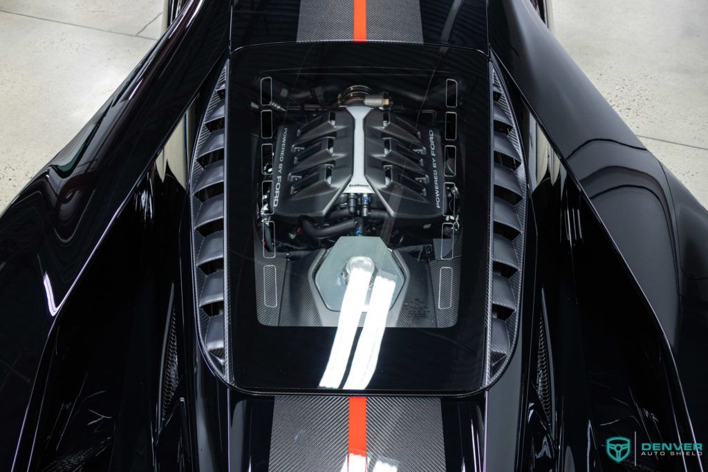 A close up of the engine of a black car