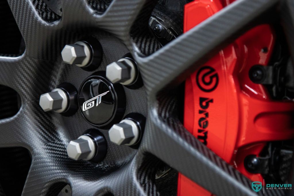 A close up of a brembo brake on a car wheel