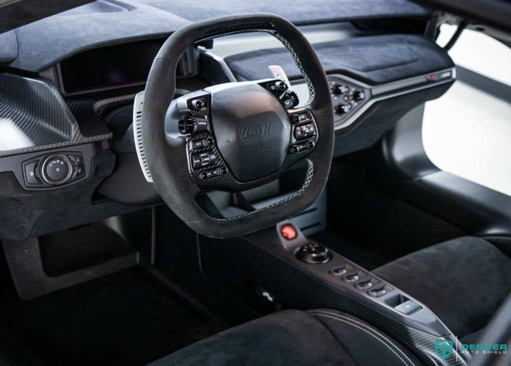 The interior of a car with a steering wheel and dashboard.