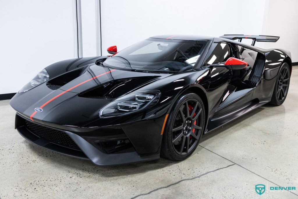 A black ford gt is parked in a garage.