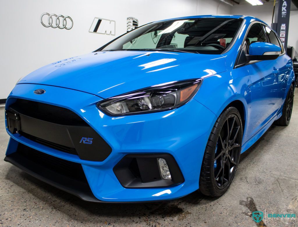 A blue ford focus rs is parked in a garage