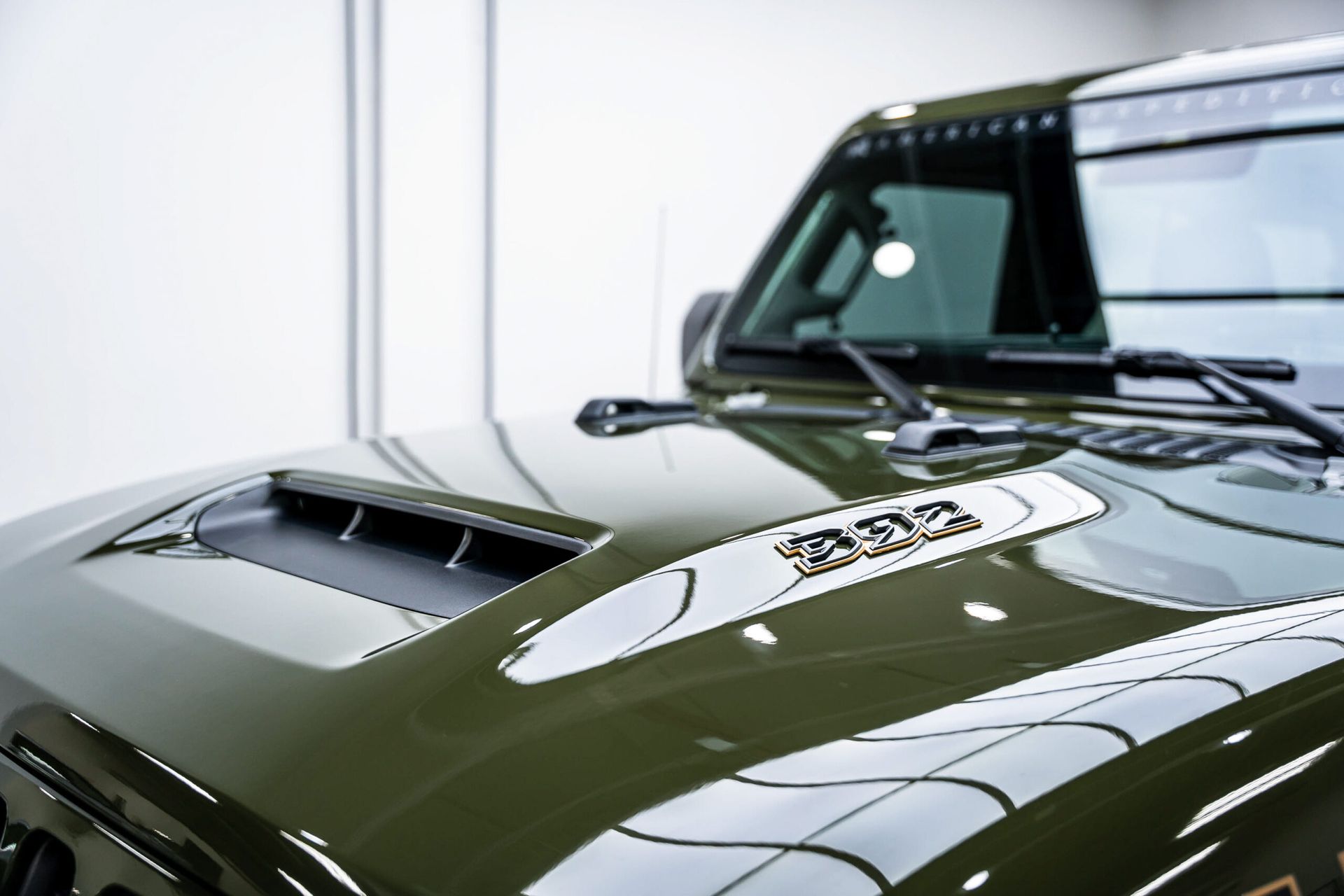 A close up of the hood of a green jeep