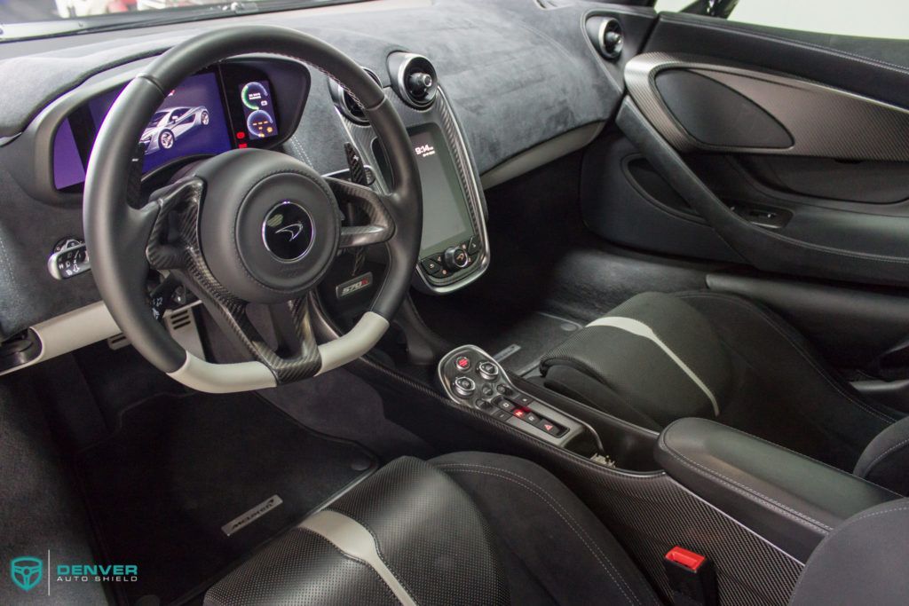 The interior of a mclaren car with a steering wheel