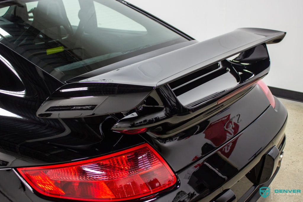 A black car with a spoiler on the back of it