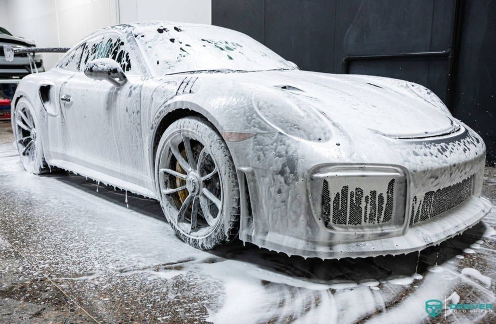 A porsche 911 turbo s is covered in foam.