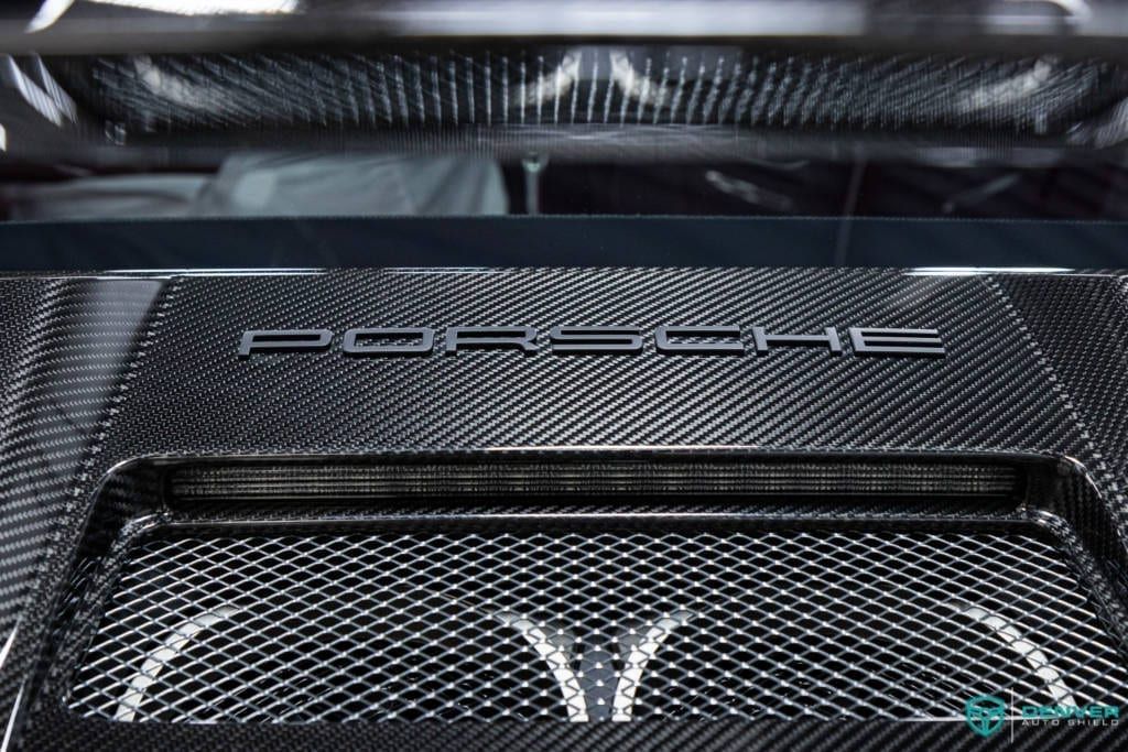 A close up of the hood of a porsche car.