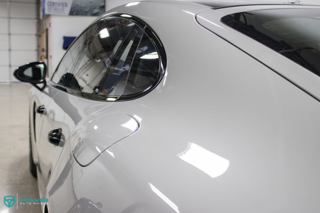 A white sports car is parked in a garage.