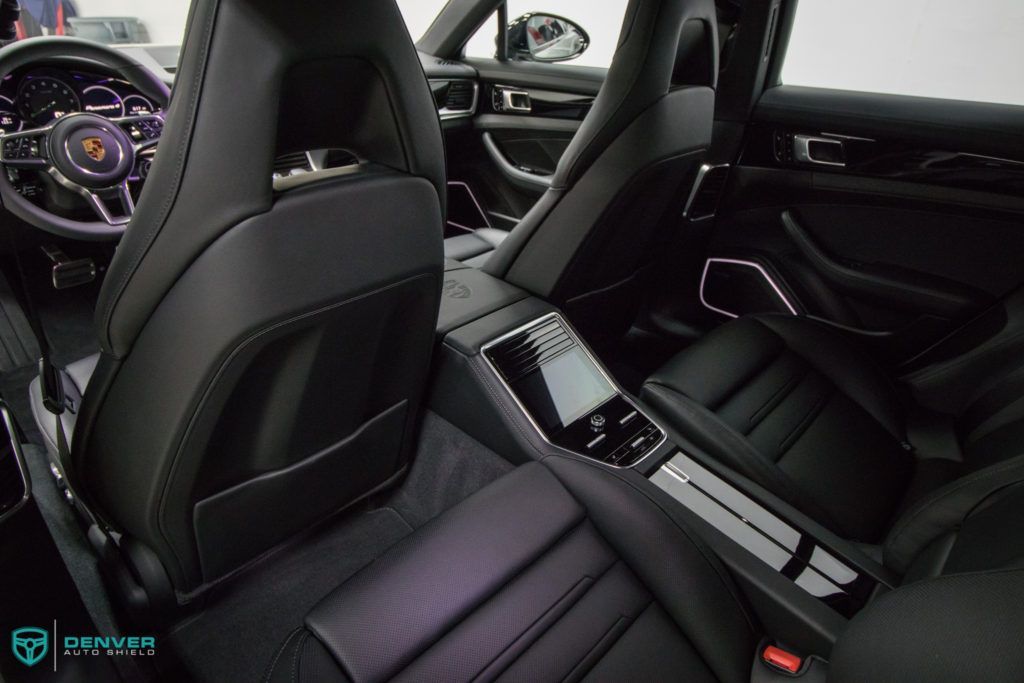 The interior of a porsche panamera with black leather seats