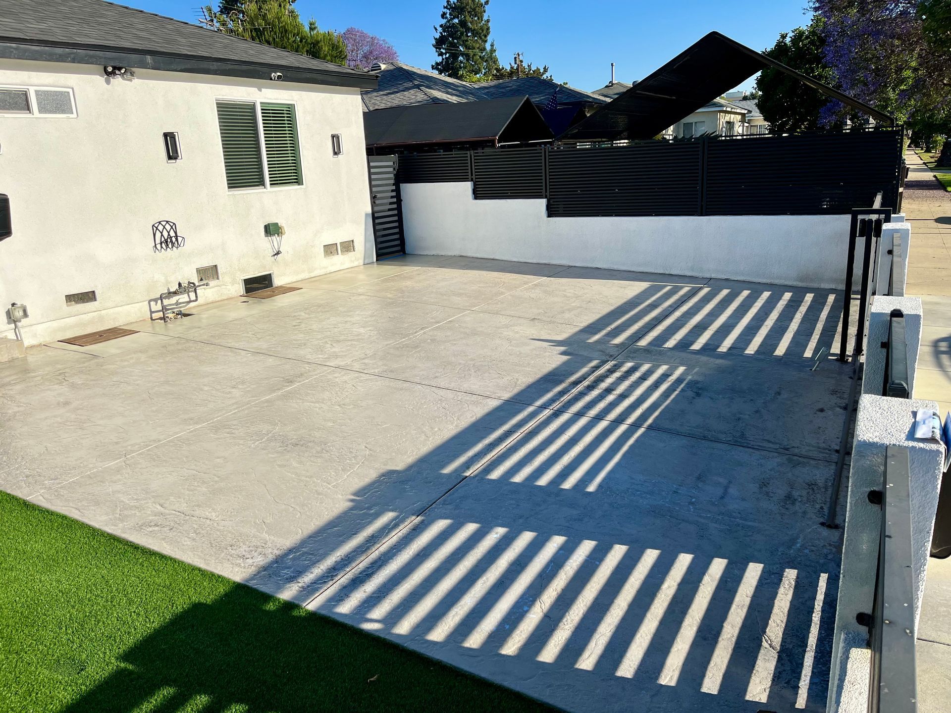 A white house with a black fence in front of it