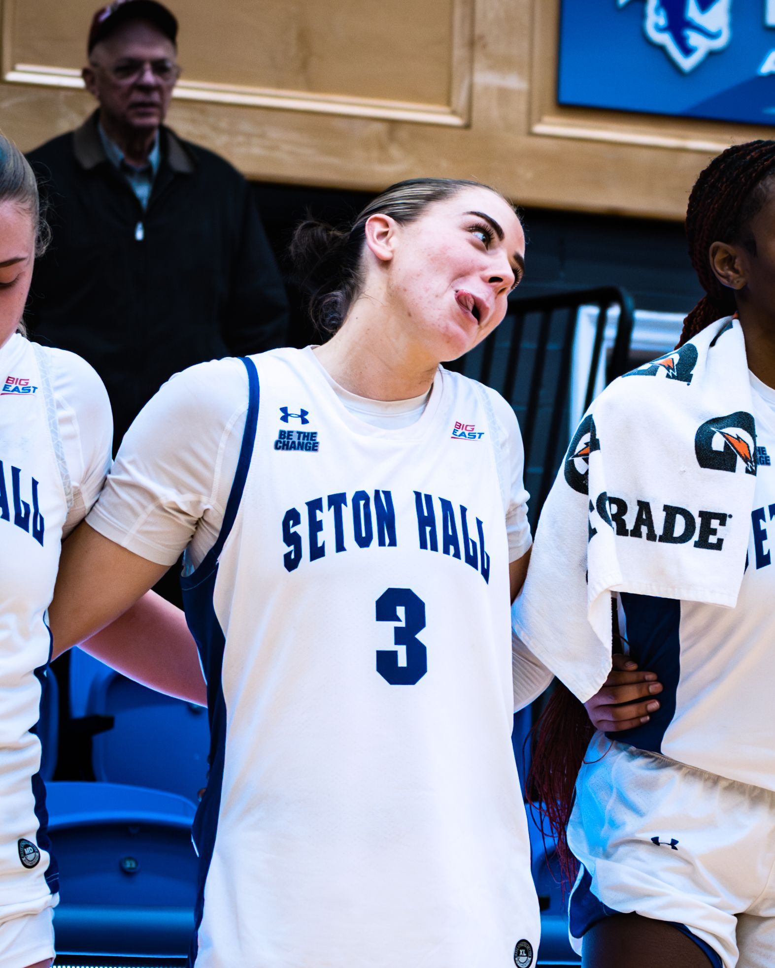 Seton Hall basketball player in white jersey #3, smiling during a game ceremony